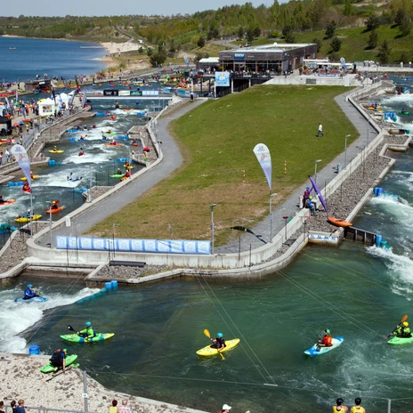 View of the white water facility in the Markkleeberg Canoe Park for the paddling festival with numerous sports enthusiasts in canoes on the water, water sports, leisure activity
