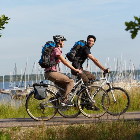 A man and a woman cycling around Lake Cospuden on the Neuseenland cycle route, active vacation