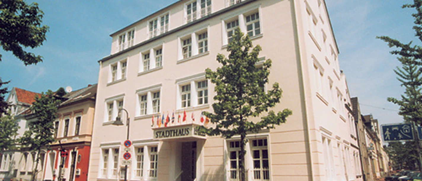 Arthotel ANA Fleur Vierstöckiges Arthotel ANA Fleur im klassischen Stil, umgeben von Bäumen, unter blauem Himmel.