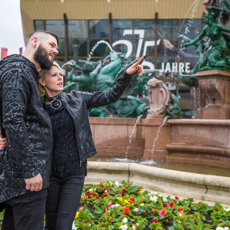 Couple in black costumes as visitors of the WGT Leipzig in front of the Gewandhaus at the Mendebrunnen, Events, Culture, Scene, Music