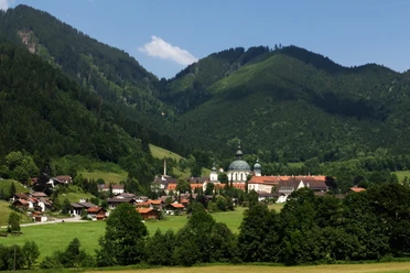 Ettal Blick auf das Kloster Ettal mit umgebenden Wäldern und Bergen an einem sonnigen Tag.