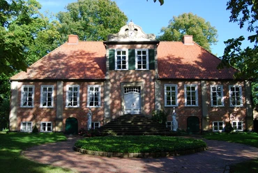 Fikensolt4.JPG Ein historische Backsteinherrenhaus mit symmetrischem Rotdach und gepflegtem Garten.