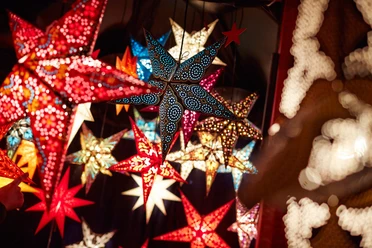 Colorful decoration stars Colorful, shining stars at a Christmas market in Cologne's Stadtgarten.