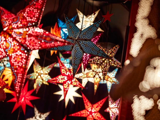 Colorful decoration stars Colorful, shining stars at a Christmas market in Cologne's Stadtgarten.