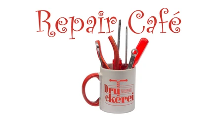 Design ohne Titel (1).jpg Weiße Tasse mit rotem Aufdruck und Griff, gefüllt mit Werkzeug. Im Hintergrund steht "Repair Café".