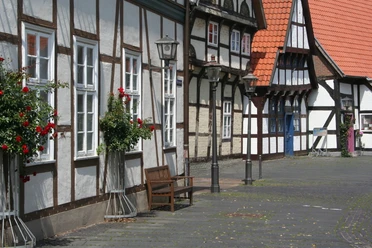 Altstadt Nienburg Half-timbered houses in Nienburg with red roof tiles, decorated with flowers and historic street lamps.