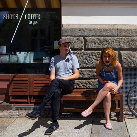 The Danish-Czech team of the 7 Shots Café sits in front of the restaurant and has fun, Gastro in Leipzig, Café