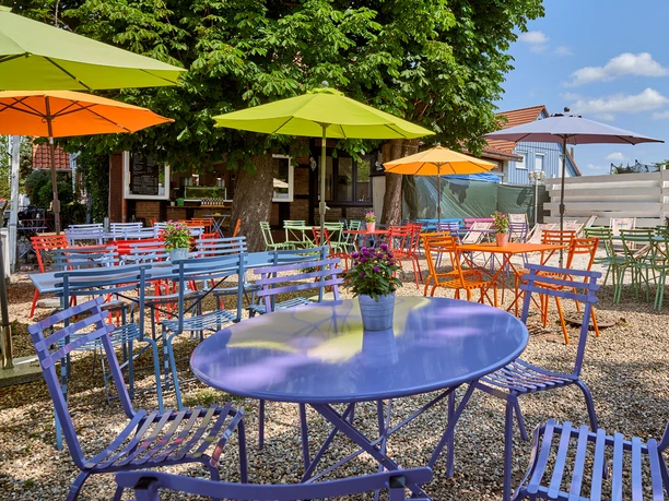 Terrace with colorful tables, chairs and parasols