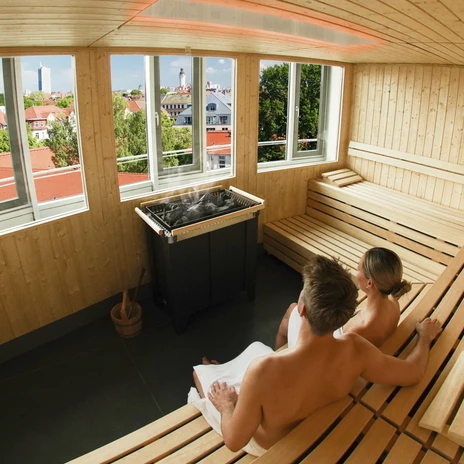 Two people sitting in a sauna and looking at the Leipzig skyline, Wellness in Leipzig, Sauna