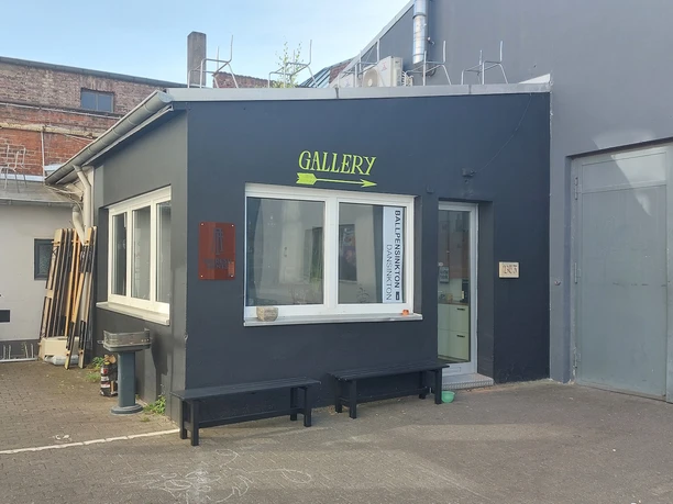 Arty Farty A modern gallery entrance with subtle colors and clean lines in an urban environment.