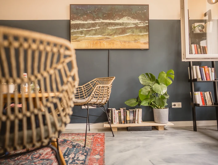 Hi Kalle Cafe, Bochum Das Foto zeigt einen stilvoll eingerichteten Raum mit Rattanstühlen und Pflanzen.