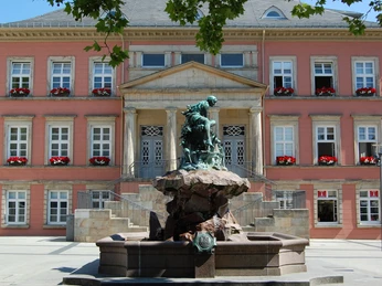 Donopbrunnen auf dem Detmolder Marktplatz Bronzefigur des Donopbrunnens vor dem historischen Gebäude des Detmolder Marktplatzes.