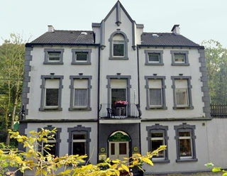 Hotel Bergische Schweiz Velbert-Langenberg Historisches Gebäude in Velbert-Langenberg, mit symmetrischer Fassade und dekorativen Fenstern.