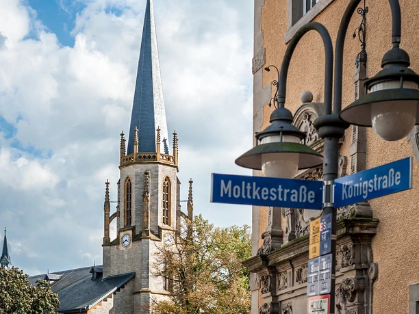St. Dionysius-Kirche in Rheine mit markantem Turm; Straßenschilder von Moltkestraße und Königstraße.