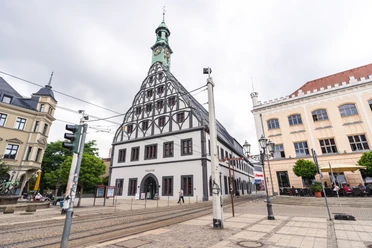 Gewandhaus (c) Oliver Göhler.jpg Ein historisches Gebäude mit markantem Fachwerk und Uhrturm in einer urbanen Umgebung.