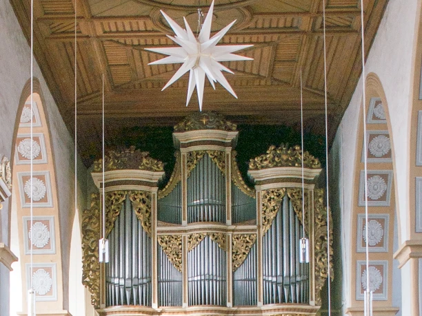 Magnificent church organ in a light-flooded nave.