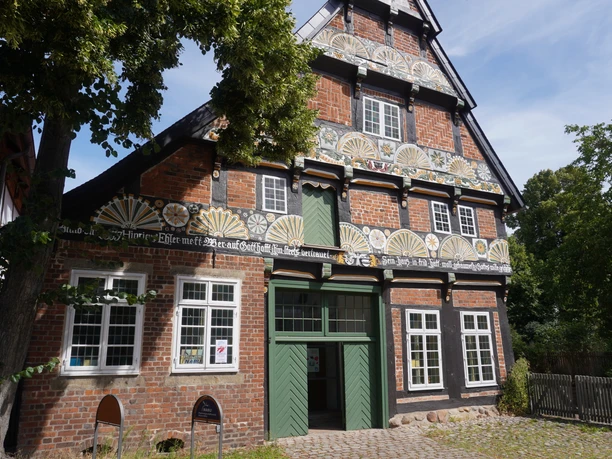 Ackerbürgerhaus Historic half-timbered farmhouse with rich ornamentation and wooden details near the village square.