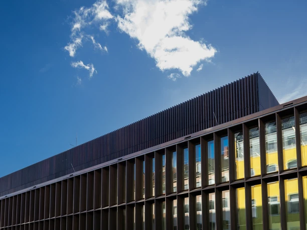 Historical Archive of the City of Cologne with Rhenish Image Archive Modern building with blue mirror glass windows under a clear sky with scattered clouds.