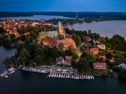 Abendstimmung über der Domhalbinsel, Jens Butz.jpg Luftaufnahme der Domhalbinsel bei Abendlicht mit Wasser und Gebäuden