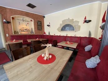 Pokoj pro hosty Café Welyn Gemütliches Café mit roten Polsterbänken und Holztischen, weihnachtlich dekoriert mit Kerzen, Lichterketten und kleinen Figuren auf roten Tischsets.A cozy café with red upholstered benches and wooden tables, decorated for Christmas with candles, fairy lights and small figures on red placemats.Útulná kavárna s červenými čalouněnými lavicemi a dřevěnými stoly, vánočně vyzdobená svíčkami, pohádkovými světýlky a malými postavičkami na červeném prostírání.Przytulna kawiarnia z czerwonymi tapicerowanymi ławami i drewnianymi stołami, udekorowana na Boże Narodzenie świecami, lampkami i małymi figurkami na czerwonych podkładkach.Gezellig café met rood gestoffeerde banken en houten tafels, versierd voor kerst met kaarsen, feeërieke lichtjes en kleine figuurtjes op rode placemats.Accogliente caffè con panche imbottite rosse e tavoli in legno, decorato per Natale con candele, luci fiabesche e piccole figure su tovagliette rosse.