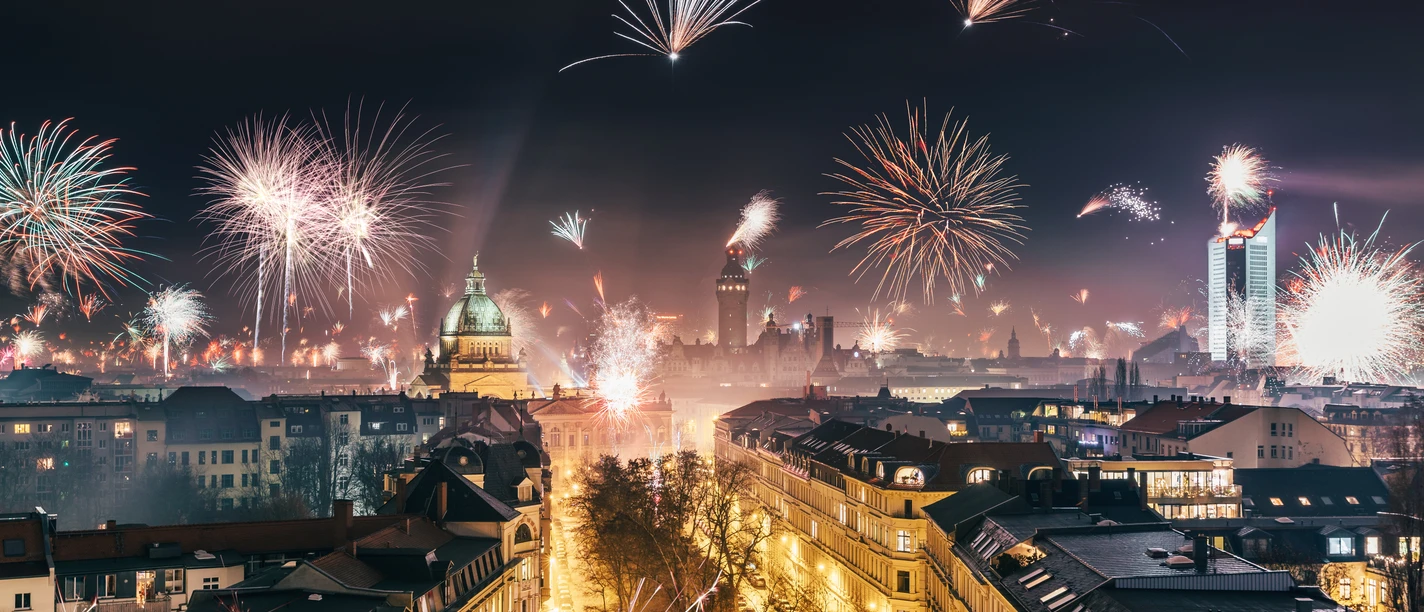 Widok z góry na centrum Lipska w Sylwestra, fajerwerki nad Federalnym Sądem Administracyjnym, Nowym Ratuszem i wieżowcem City-Hochhaus, zabytki