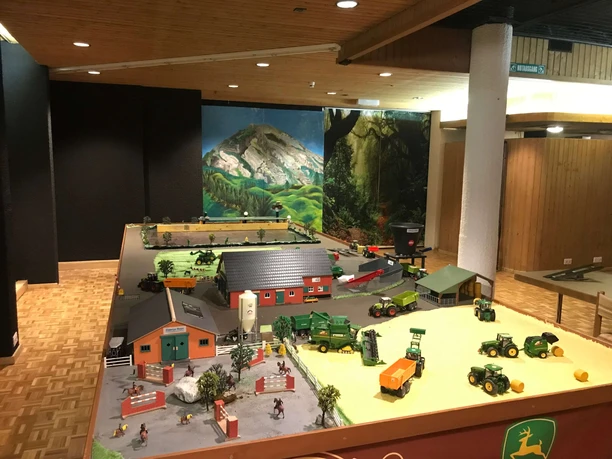 Model railway landscape with farm vehicles