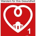 TK 1 Rotes Schild mit weißem Herz, Kurweg-Logo, Text "Wandern für Ihre Gesundheit" und die Zahl eins.