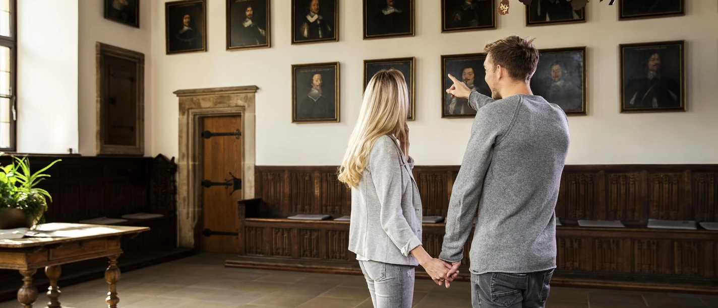 Chamber of Peace in the townhall in Osnabrück A couple looks at portraits in the historic Peace Hall of Osnabrück Town Hall.