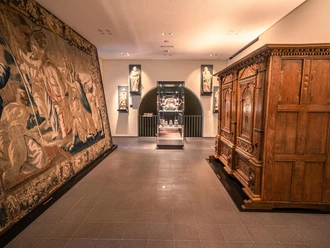 The Diocesan Museum in Osnabrück Exhibition room in the Osnabrück Diocesan Museum with sculptures, valuable tapestry and wooden cabinet.