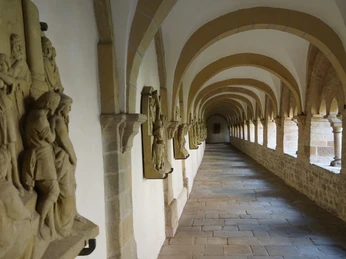 St. Peter's in Osnabrück - Cathedral Cloister Gewölbter Kreuzgang im Dom St. Petrus Osnabrück mit Skulpturen entlang der Wände und gepflastertem Boden.Vaulted cloister in St. Peter's Cathedral Osnabrück with sculptures along the walls and paved floor.Hvælvet klostergang i Peterskirken i Osnabrück med skulpturer langs væggene og et brolagt gulv.Gewelfde kruisgang in de Sint-Pieterskathedraal in Osnabrück met beelden langs de muren en een geplaveide vloer.