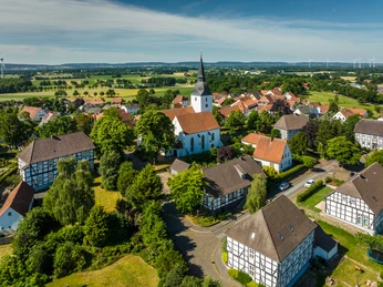 Stemwede-Stiftsort Levern-Teutoburger-Wald-Tourismus-D-Ketz-040 - Kopie-CC-BY-SA.jpg Blick über historische Fachwerkhäuser und die Stiftskirche in Levern, umgeben von grüner Landschaft.