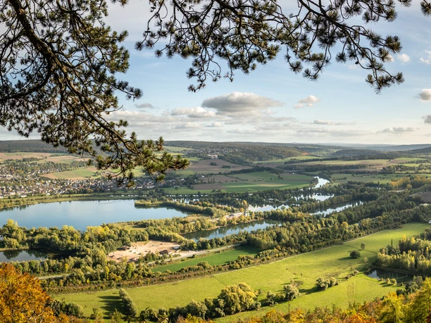 Hoexter-Rabenklippen-Teutoburger-Wald-Tourismus-D-Ketz-110-CC-BY-SA.jpg Panorama einer idyllischen Flusslandschaft im Sommer mit Wald, Fluss und hügeligem Hintergrund.