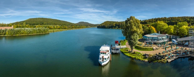 Schieder-Schwalenberg-Schiedersee-Teutoburger-Wald-Tourismus-D-Ketz-082.jpg Panorama der des Schiedersee mit Bootsanleger, umgeben von bewaldeten Hügeln und Grünflächen.