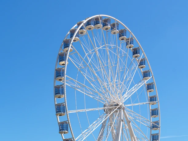 Kölner Riesenrad Großes weißes Riesenrad mit geschlossenen Gondeln vor klarem blauen Himmel