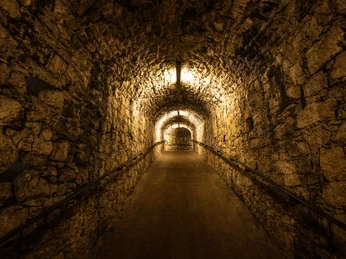 Bielefeld-Sparrenburg-Teutoburger-Wald-Tourismus-D-Ketz-020.jpg Ein schmaler, dimm beleuchteter Stein-Tunnel mit gewölbter Decke und Handläufen an beiden Seiten.