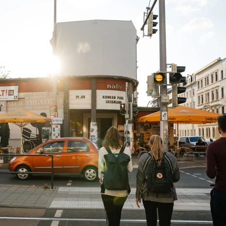 Three people in front of the naTo on Karl-Liebknecht-Straße in Leipzig in spring