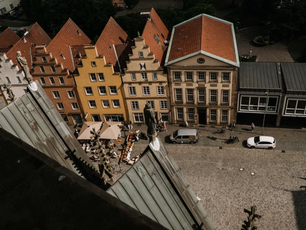 Luftansicht des EMR von der Marienkirche aus gesehen Blick auf den Platz mit farbenfrohen Giebelhäusern und Cafétischen aus der Höhe der Marienkirche.