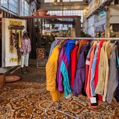 Colorful jackets and shirts on clothes rails at Westwerk in Leipzig