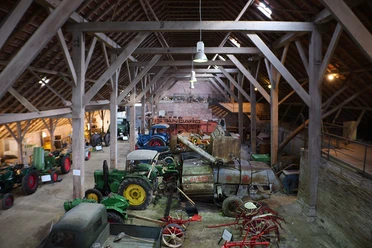 Ostfriesisches Landwirtschaftsmuseum Campen View of the museum's barn with the historic tractors and vehicles.