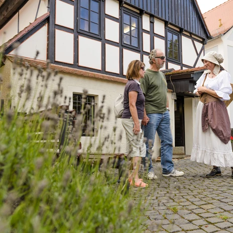 A couple and a woman in traditional costume at the Wassermühle Museum in Grimma in the Leipzig region