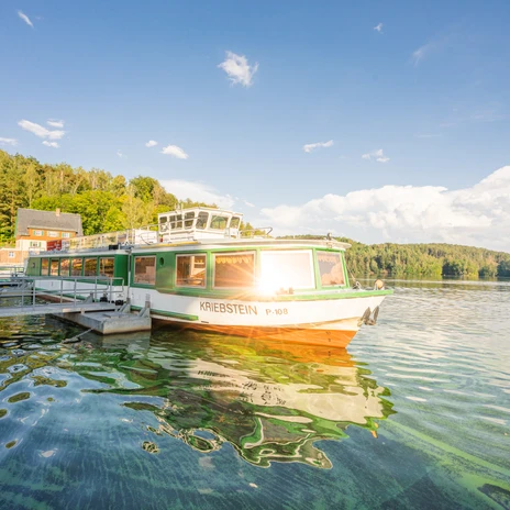 Boat with the name Kriebstein at the jetty at the Zschopau reservoir, trees, blue sky