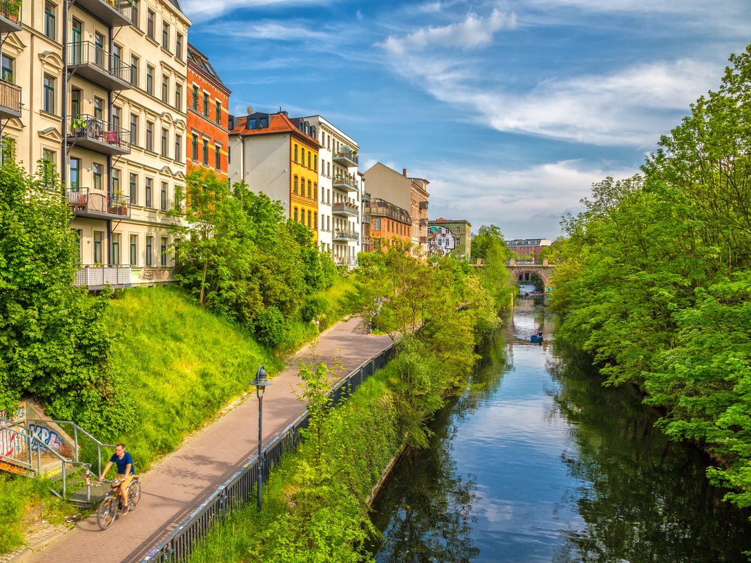 Karl-Heine-Kanal in der Wasserstadt - Fahrrad und Kanufahren in Leipzig Grünende Bäume am Karl-Heine-Kanal im Sommer, bunte Häuser, blauer Himmel, WasserGreen trees on the Karl Heine Canal in summer, colorful houses, blue sky, waterZelené stromy na kanálu Karla Heineho v létě, barevné domy, modrá obloha, vodaZielone drzewa nad kanałem Karla Heinego latem, kolorowe domy, błękitne niebo, wodaGroene bomen op het Karl Heine kanaal in de zomer, kleurrijke huizen, blauwe lucht, waterAlberi verdi sul canale Karl Heine in estate, case colorate, cielo azzurro, acqua