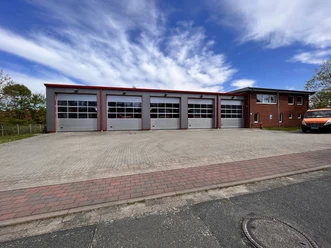FFW Amelinghausen Feuerwehrgerätehaus Amelinghausen mit fünf Fahrzeughallen und Nebengebäude unter blauem Himmel.