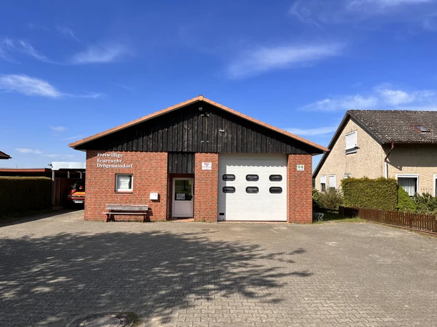 Freiwilligen Feuerwehr Drögennindorf . Gerätehaus der Freiwilligen Feuerwehr Drögennindorf mit Backsteinfassade und weißem Rolltor.