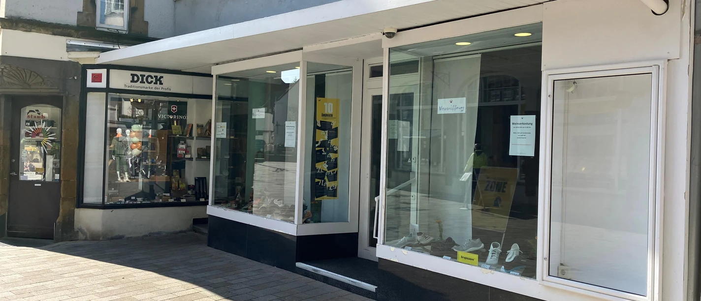 Schaufenster von Onkel Arne mit Schuhen und Nachbargeschäft in einer Fußgängerzone