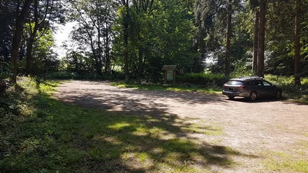 Car park Dorotheenhofer Weg Salem Forest edge parking area with gravel ground, single parked car and a wooden info board.