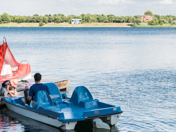 Pedal boat hire at Lake Kulkwitz in Leipzig's New Lake District Blue pedal boats are anchored on the shores of Lake Kulkwitz, ready for long cruises.