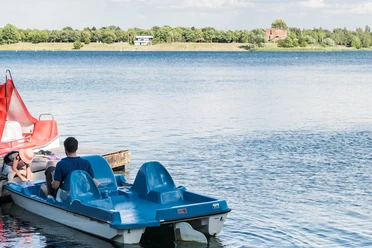 Tretbootausleih am Kulkwitzer See im Leipziger Neuseenland Blue pedal boats are anchored on the shores of Lake Kulkwitz, ready for long cruises.