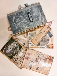 Alte Notizbücher, kreative Collagen und Vintage-Fotos auf einem Tisch arrangiert.