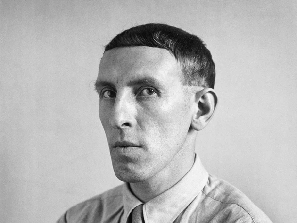 The Photographic Collection/SK Stiftung Kultur Black and white portrait of a serious-looking, slim man in a shirt and tie, looking thoughtful and calm.